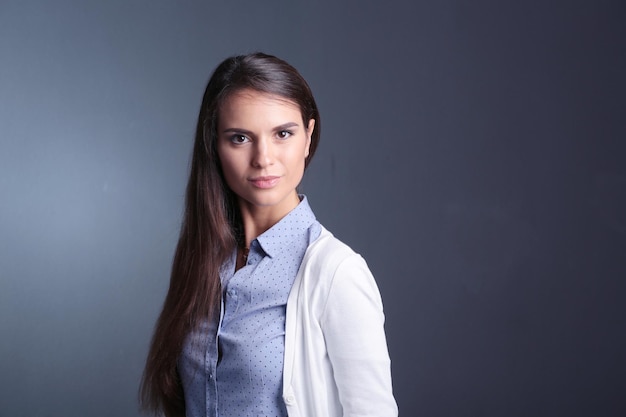 Portrait of a businesswoman against dark background