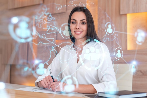 Portrait of businesswoman in formal wear working with documents and looking for employees to hire new candidates for international business consulting HR social media icons over office background