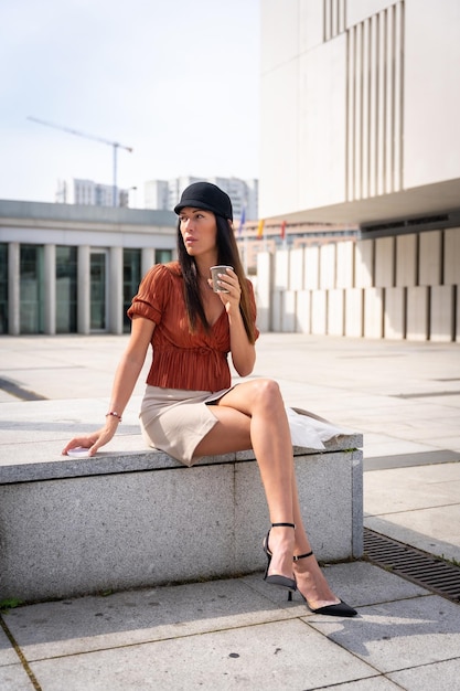 Portrait of a businesswoman outside the office having a hot coffee