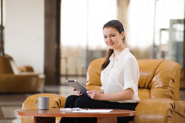 Portrait of busy business woman working and sitting at sofa