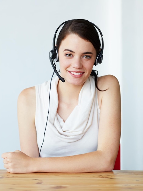 Portrait call center and woman consultant or agent for business communication help or online support Professional telemarketing and face of happy virtual assistant or person on a wall background