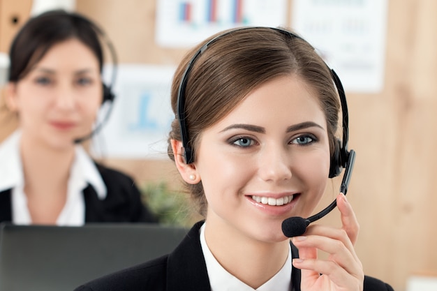 Portrait of call center worker accompanied by her team