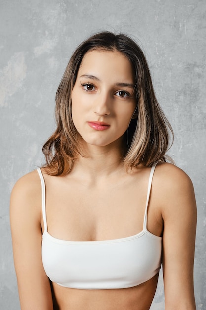 Portrait of calm young woman in white tube top