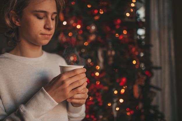 Portrait of candid authentic dreamer boy teenager in sadness depressing emotion at home Xmas