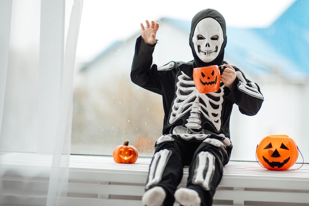 Portrait of candid authentic gen Z boy have fun in skeleton costume at Halloween holiday