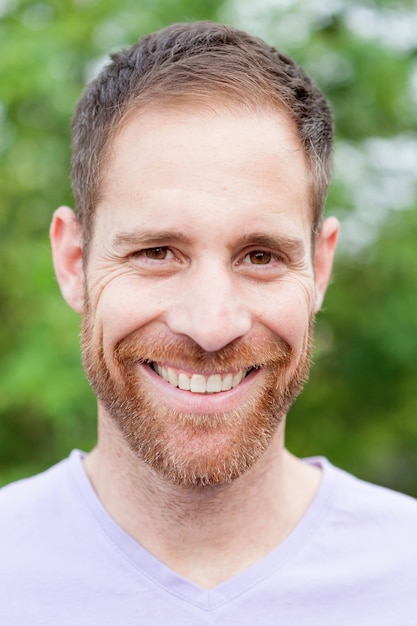 Portrait of a casual bearded man in a park