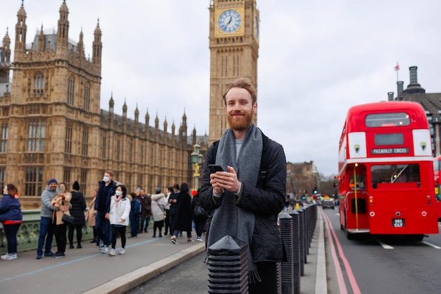 Portrait of a casual man with a smartphone in London