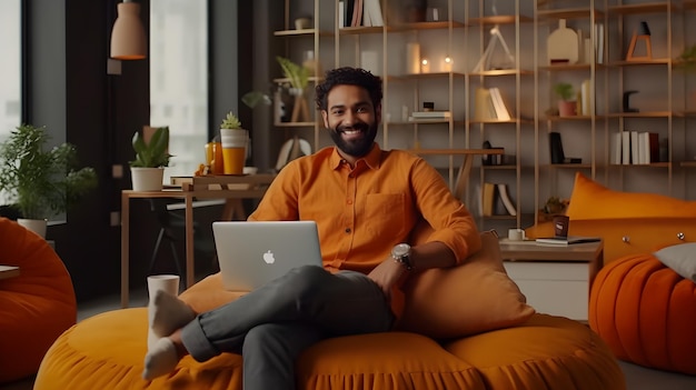 Portrait of casually dressed positive indian man sitting on orange bean bag pouffe and smiling Generative Ai