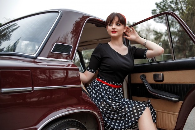 Portrait of a Caucasian beautiful young girl in a black vintage dress