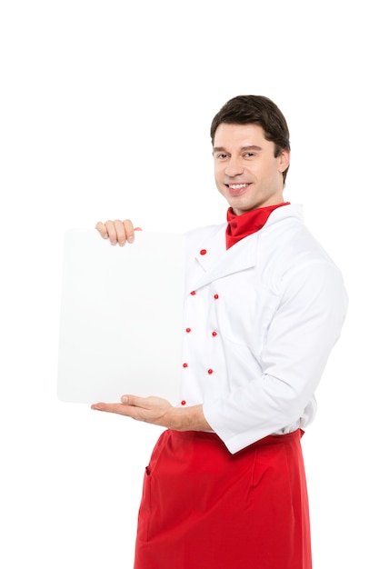 Portrait caucasian man in chef uniform holds a nameplate for menu on white.