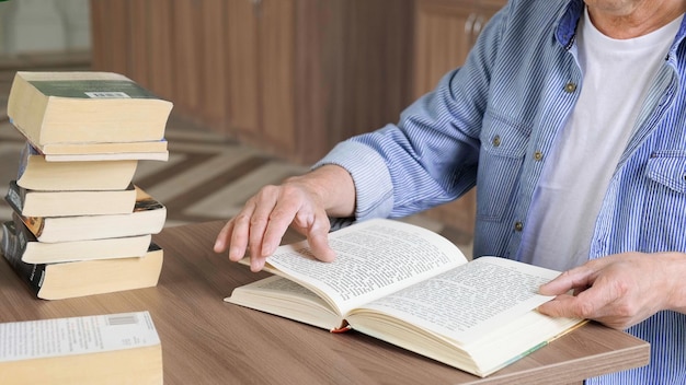 Portrait of caucasian Senior man working with book in public library Adult student at the library