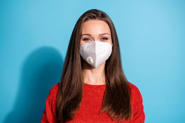 Portrait of charming girl look good in camera wear respirator pullover isolated over blue color background