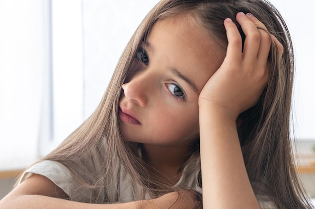 Portrait of a charming little girl in bed early in the morning