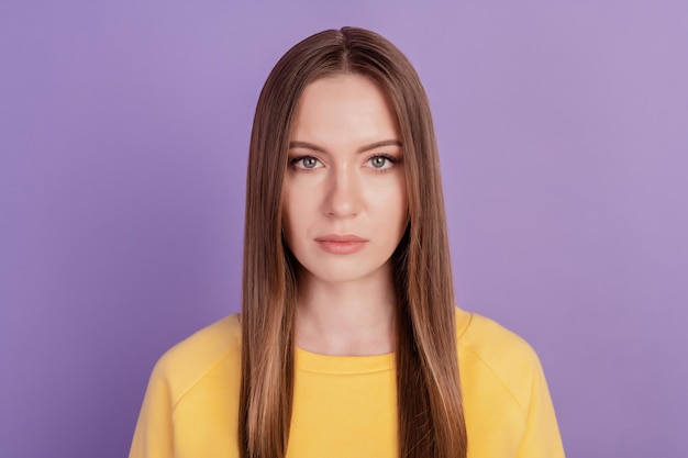 Portrait of charming pretty calm focused lady look camera on violet background