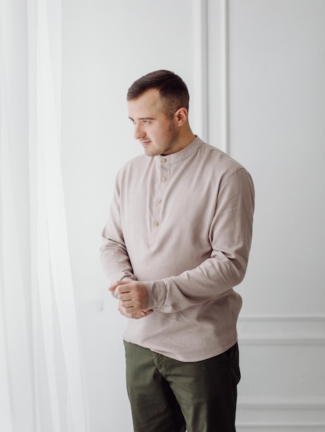 Portrait of a charming successful young businessman in a brown shirt