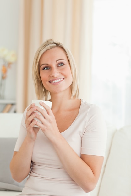 Portrait of a charming woman holding a cup of tea