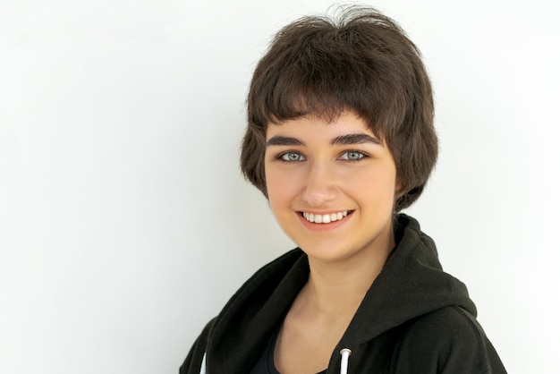 Portrait charming young woman in black clothes smiling broadly with white teeth