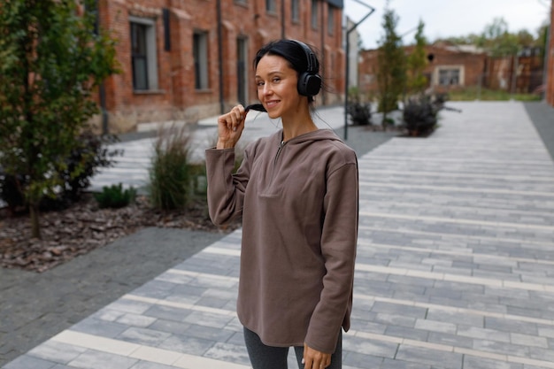 Portrait of cheerful brunette in headphones