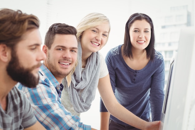 Portrait of cheerful business team working at desk 