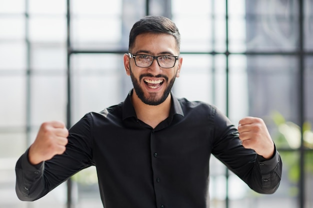 Portrait of a cheerful businessman celebrating his success