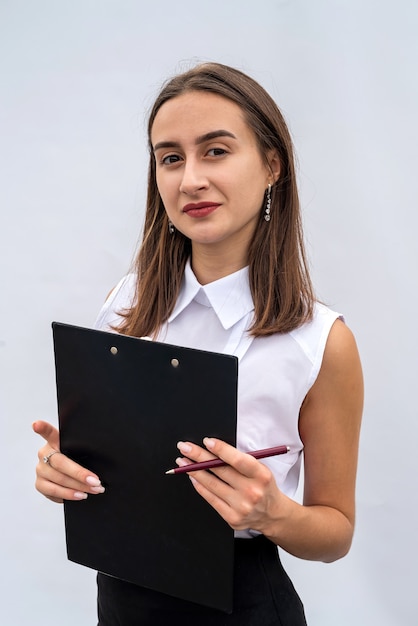 Portrait of cheerful businesswoman with clipboard, isolated on white