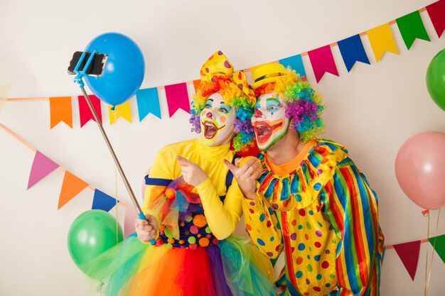 Portrait of cheerful clowns at a party