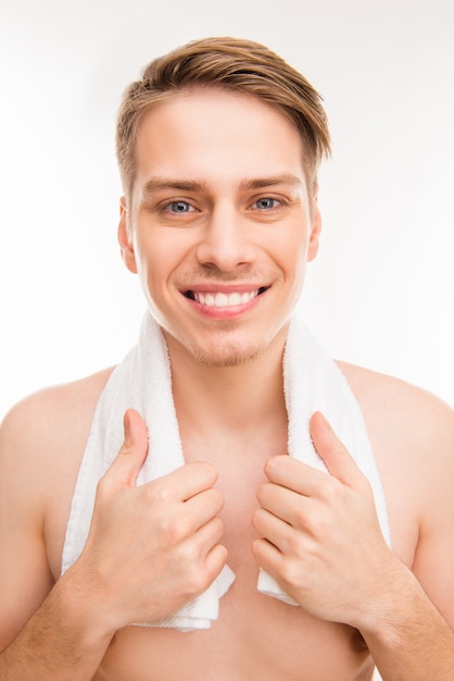 Portrait of cheerful hansome young healthy man with towel on his neck