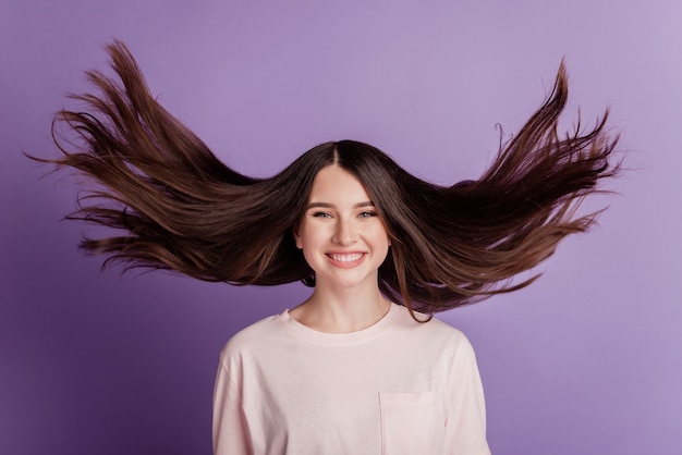 Portrait of cheerful happy beautiful girl wind blow face toothy smile on violet background