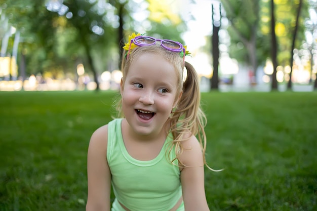 Portrait of a cheerful little girl in the park