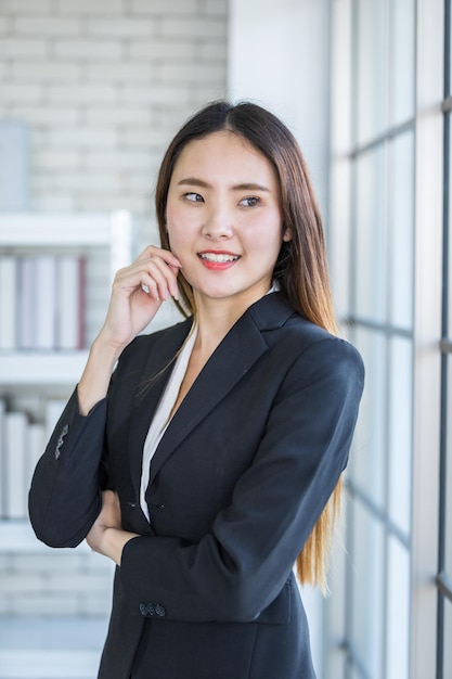 Portrait of a cheerful mature Asian businesswoman at In the office room backgroundbusiness expressed confidence embolden and successful concept