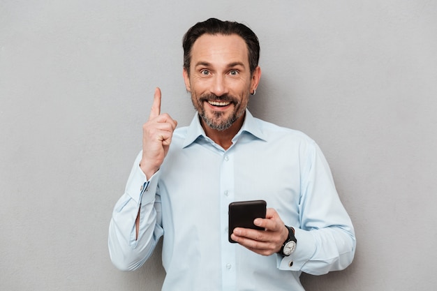 Portrait of a cheerful mature man dressed in shirt