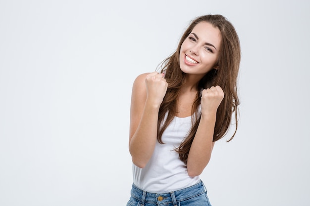 Portrait of a cheerful woman celebrating her success isolated on a white background