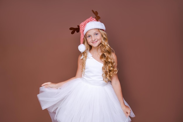 Portrait cheerful young teen girl dressed as Christmas deer standing