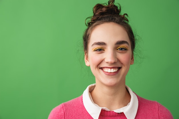 Portrait of a cheerful young woman standing isolated