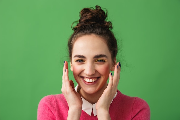 Portrait of a cheerful young woman standing isolated