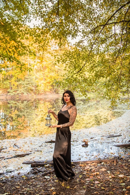 Portrait of chic darkhaired tattooed young woman