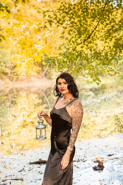 Portrait of chic darkhaired tattooed young woman