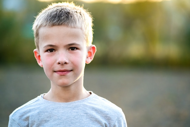 Portrait of a child boy outdoors on a warm sunny summer day.