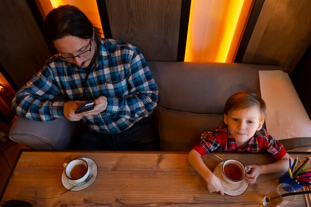 Portrait of child drinking tea in cafe