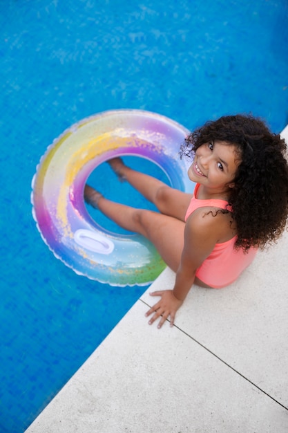 Portrait of child at the pool with floater