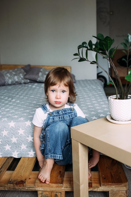 Portrait child preschooler at home looking seriously into the camera