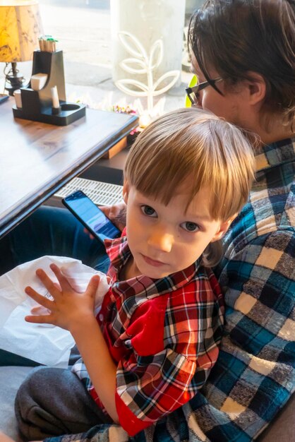 Portrait of child with his father drawing with pencils in cafe