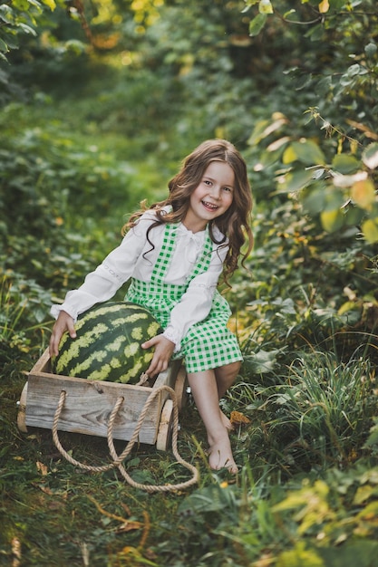 Portrait of a child with a huge watermelon in the cart 1894