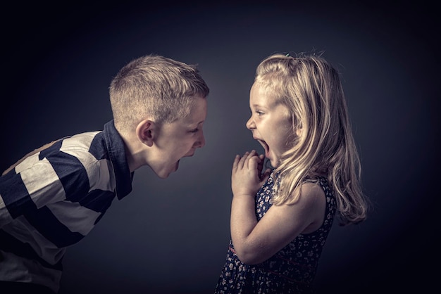 Portrait of children shouting and arguing