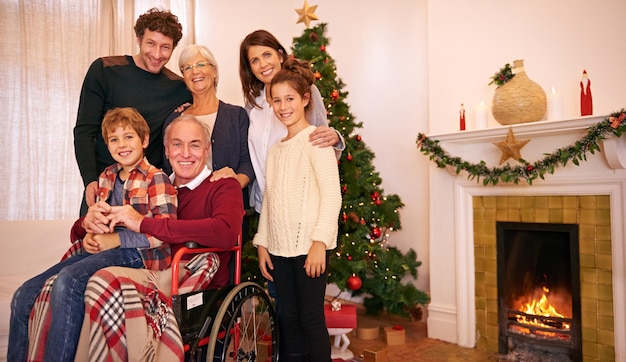 Portrait Christmas and family celebrate holiday together grandparents parents and child smile in family home Christmas tree fireplace and generations love and tradition with happy family