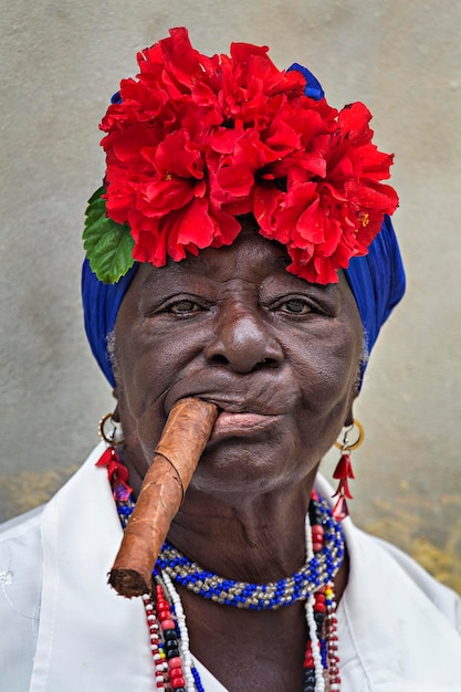 Portrait of a colorful Cuban woman with a Cuban cigar in her mouth