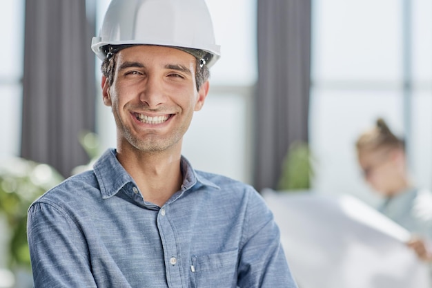 Portrait of a confident businessman in a protective helmet