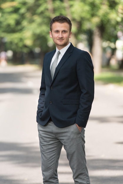 Portrait Of Confident Businessman While Standing Outdoors In Park