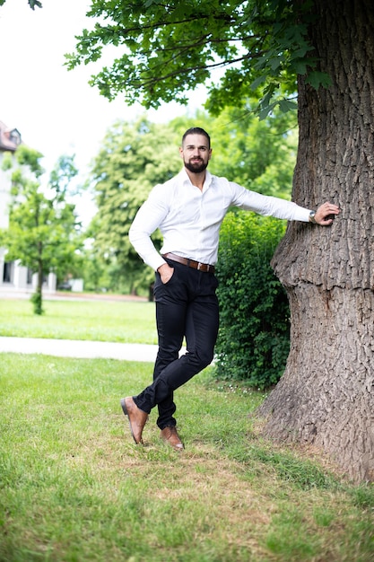 Portrait Of Confident Businessman While Standing Outdoors In Park