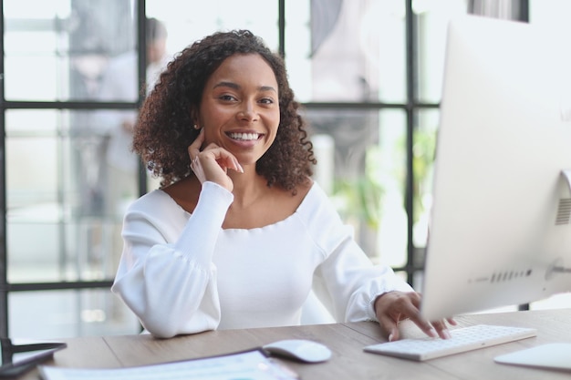 Portrait of a confident businesswoman with team in the background